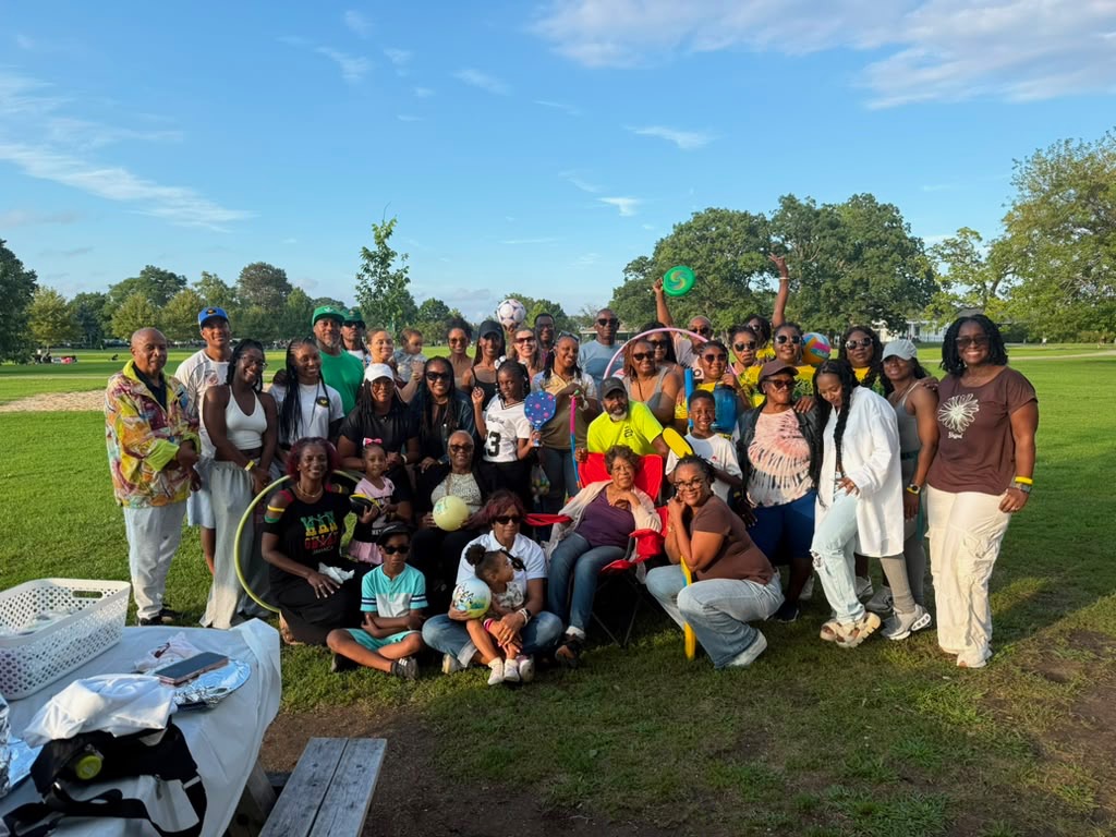 Friends of Porus picnic attendees posing together with balls, hula hoops and frisbees in the park