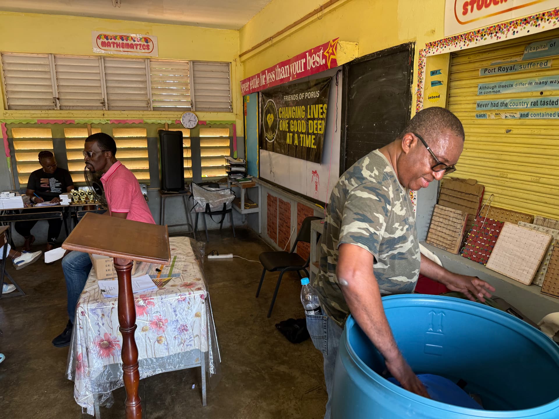 Canyute Smith, leader with Friends of Porus, preparing giveback supplies in a Porus Primary School classroom